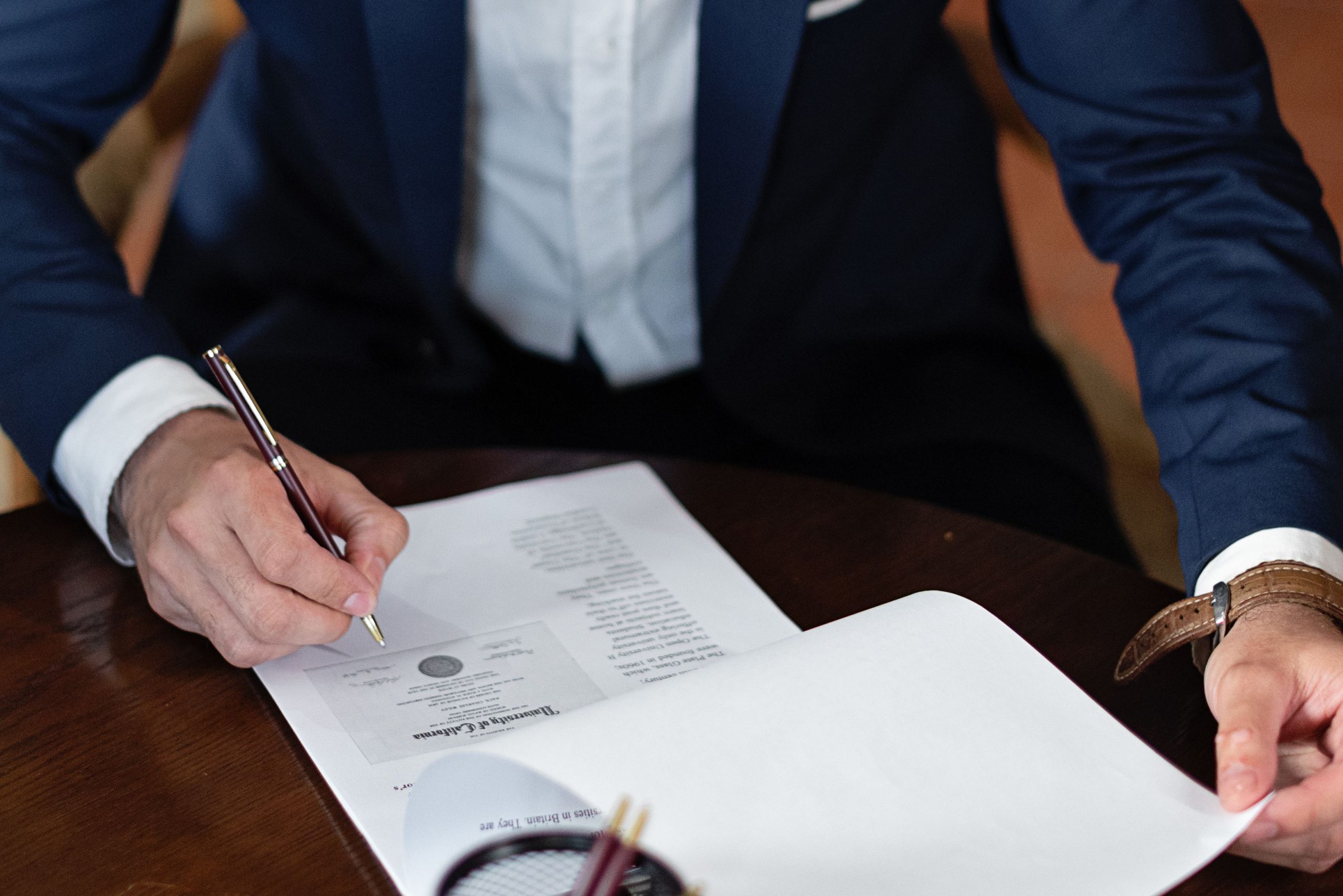 AI-Generated Contracts and Legal Documents: Why Attorneys Are Turning to AI Detection Tools Attorney signing an AI-generated legal contract at a desk in an office