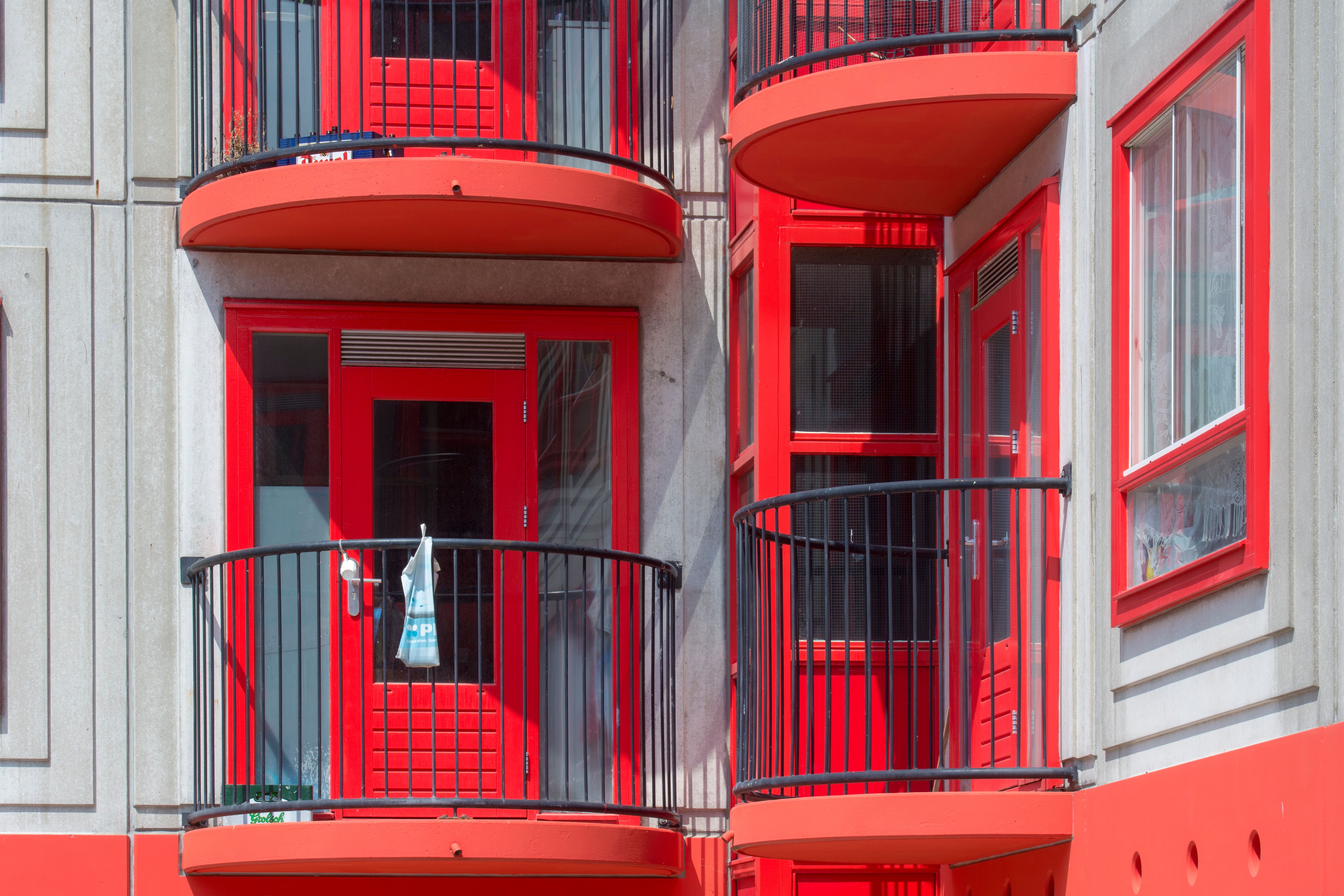 Vibrant red balconies on a modern residential building facade