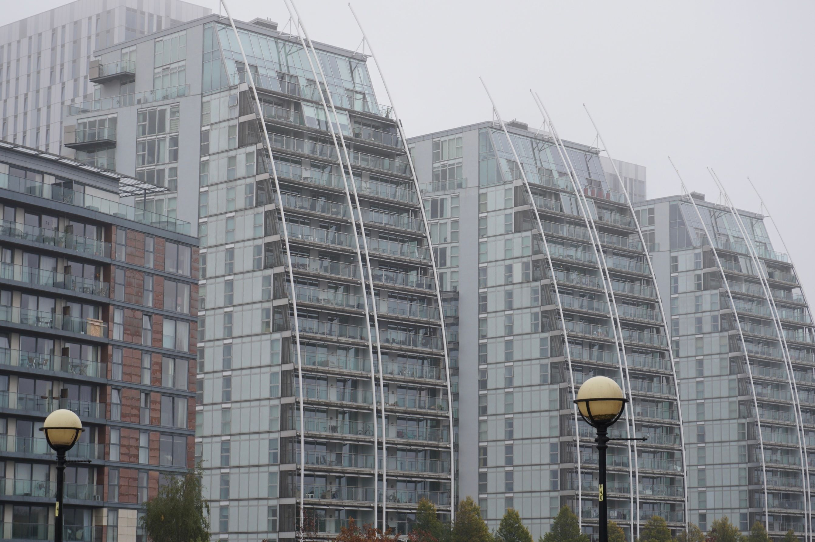 Foggy morning view of modern apartment buildings in Salford, England
